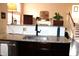 Modern kitchen featuring granite countertops, stainless steel sink, and views into the living area at 2120 Dakota Dr, Franklin, IN 46131