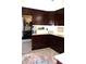 Kitchen boasts dark cabinetry, granite countertops, stainless steel appliances and tile flooring at 2120 Dakota Dr, Franklin, IN 46131