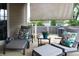 Inviting covered patio with cushioned seating and tropical print pillows perfect for outdoor relaxation at 2120 Dakota Dr, Franklin, IN 46131