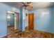 Bedroom featuring hardwood floors, light blue walls, a closet, and ceiling fan at 219 S Sherman Dr, Indianapolis, IN 46201
