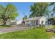 A charming home with a detached garage, lush green lawn, and mature trees creates a serene atmosphere at 219 S Sherman Dr, Indianapolis, IN 46201