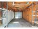 Attached garage with concrete floor and exposed rafters providing a functional storage space at 219 S Sherman Dr, Indianapolis, IN 46201