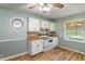 Traditional kitchen featuring vintage appliances, natural light, and laminate flooring at 219 S Sherman Dr, Indianapolis, IN 46201