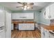 Functional kitchen layout featuring white cabinetry, laminate countertops, and essential appliances at 219 S Sherman Dr, Indianapolis, IN 46201