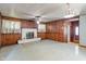Large living room featuring a decorative fireplace and wood paneling at 219 S Sherman Dr, Indianapolis, IN 46201
