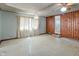 Open living room with wood paneling and ceiling fan at 219 S Sherman Dr, Indianapolis, IN 46201