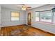 A spacious living room with a large window, hardwood floors, and a ceiling fan at 219 S Sherman Dr, Indianapolis, IN 46201