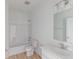 Well-lit bathroom features tile flooring, a shower-tub combo, and a vanity with a large mirror at 2257 Aviary Ln, Danville, IN 46122