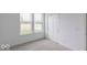 Bright bedroom features neutral carpet, natural light from large windows, and a built-in closet for ample storage at 2257 Aviary Ln, Danville, IN 46122