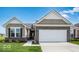Charming, single-story home with a brick facade, attached garage, and well-manicured lawn in a suburban neighborhood at 2257 Aviary Ln, Danville, IN 46122
