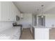 Bright kitchen with white cabinets, stainless steel appliances, and a center island with wood-look flooring at 2257 Aviary Ln, Danville, IN 46122