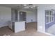 Open-concept kitchen featuring a large island with a sink, stainless steel appliances, and access to an outdoor space at 2257 Aviary Ln, Danville, IN 46122