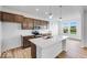 Modern kitchen with stainless steel appliances, white countertops, and an island with bar seating at 2257 Aviary Ln, Danville, IN 46122