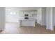 Open-concept kitchen with white cabinetry, stainless steel appliances, and a center island with a sink at 2257 Aviary Ln, Danville, IN 46122