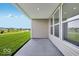 Covered patio showcasing outdoor space with views of the green lawn and neighborhood pond at 2257 Aviary Ln, Danville, IN 46122