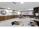Finished basement area with wood paneling, plush seating, and a decorative cow hide rug at 2325 Melody Ln, Anderson, IN 46012