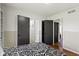 Bedroom featuring grey doors, neutral walls and hardwood floors, plus a black and white patterned comforter at 2325 Melody Ln, Anderson, IN 46012