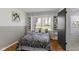 Cozy bedroom featuring a window view, built-in shelves, and a unique black and white patterned comforter at 2325 Melody Ln, Anderson, IN 46012