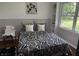 Charming bedroom with black and white patterned bedding, built-in shelving, and natural light at 2325 Melody Ln, Anderson, IN 46012