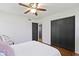 Bedroom showcasing hardwood floors, a ceiling fan, and a closet with black doors at 2325 Melody Ln, Anderson, IN 46012