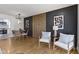 Stylish dining area with modern lighting, wood accent wall, and seating for six at 2325 Melody Ln, Anderson, IN 46012