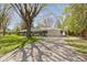 Beautiful ranch home featuring a spacious lawn, large driveway, attached garage, and mature shade tree at 2325 Melody Ln, Anderson, IN 46012