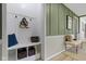 Bright hallway with a mudroom bench and stylish green walls at 2325 Melody Ln, Anderson, IN 46012