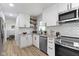 Updated kitchen boasting white cabinets, stainless appliances, and modern backsplash at 2325 Melody Ln, Anderson, IN 46012