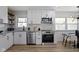 Bright kitchen with white cabinets, stainless steel appliances, and a window view at 2325 Melody Ln, Anderson, IN 46012