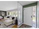 Bright and airy living room featuring hardwood floors and views of the front yard from the entry at 2325 Melody Ln, Anderson, IN 46012