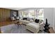 Well-lit living room featuring hardwood floors, a large window, and stylish modern furniture at 2325 Melody Ln, Anderson, IN 46012