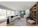 Bright living room with hardwood floors, a modern fireplace, and plenty of natural light at 2325 Melody Ln, Anderson, IN 46012