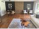 Modern living room with a dining area, featuring a decorative wooden panel and stylish decor at 2325 Melody Ln, Anderson, IN 46012