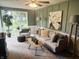 Comfortable living room with neutral green walls, plush seating, and an abundance of natural light at 2325 Melody Ln, Anderson, IN 46012