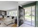 Bright living room with stylish decor, hardwood floors, and a view of the front yard at 2325 Melody Ln, Anderson, IN 46012