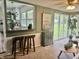 Open-concept space with a pass-through to a white kitchen and views of the backyard at 2325 Melody Ln, Anderson, IN 46012