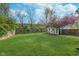 Spacious backyard features lush green lawn, mature trees, and privacy fencing at 2539 E 68Th St, Indianapolis, IN 46220