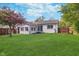 Beautiful backyard featuring a well-maintained lawn, mature trees, and a patio at 2539 E 68Th St, Indianapolis, IN 46220