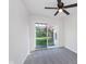 Cozy bedroom with carpet, sliding door access to backyard, and a ceiling fan at 2539 E 68Th St, Indianapolis, IN 46220