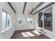 Bright dining room with hardwood floors, beamed ceilings, and multiple windows for natural light at 2539 E 68Th St, Indianapolis, IN 46220