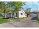 Well-maintained exterior of a single-story home with a private driveway and detached garage at 2539 E 68Th St, Indianapolis, IN 46220