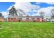 Expansive backyard with a well-maintained lawn and a charming red deck, ideal for outdoor enjoyment at 2610 S Sheridan Ave, Indianapolis, IN 46203