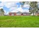 Charming single-story brick home with a spacious front lawn and manicured landscaping at 2610 S Sheridan Ave, Indianapolis, IN 46203