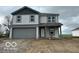 Charming two-story home with a gray garage door and gray accents under a cloudy sky at 3312 W Longbranch Dr, Monrovia, IN 46157