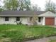 Ranch style home with a lawn and bushes obscuring the front of the house at 3510 Maura Ct, Indianapolis, IN 46235