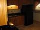 The kitchen features ample cabinet space, a black refrigerator, and sink at 3510 Maura Ct, Indianapolis, IN 46235