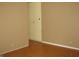 An empty room with beige painted walls and a light wood floor at 3510 Maura Ct, Indianapolis, IN 46235