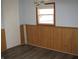 Room featuring a light blue painted walls, wood paneled walls and a vinyl floor at 3510 Maura Ct, Indianapolis, IN 46235