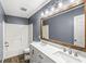 Bathroom with double sinks and a shower featuring tile surround at 3582 Fieldhurst Ln, Plainfield, IN 46168