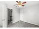 This bedroom features neutral paint, carpet flooring, ceiling fan, and two doors at 3582 Fieldhurst Ln, Plainfield, IN 46168